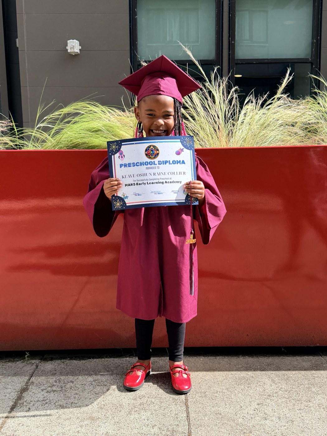 A child celebrating a graduation milestone